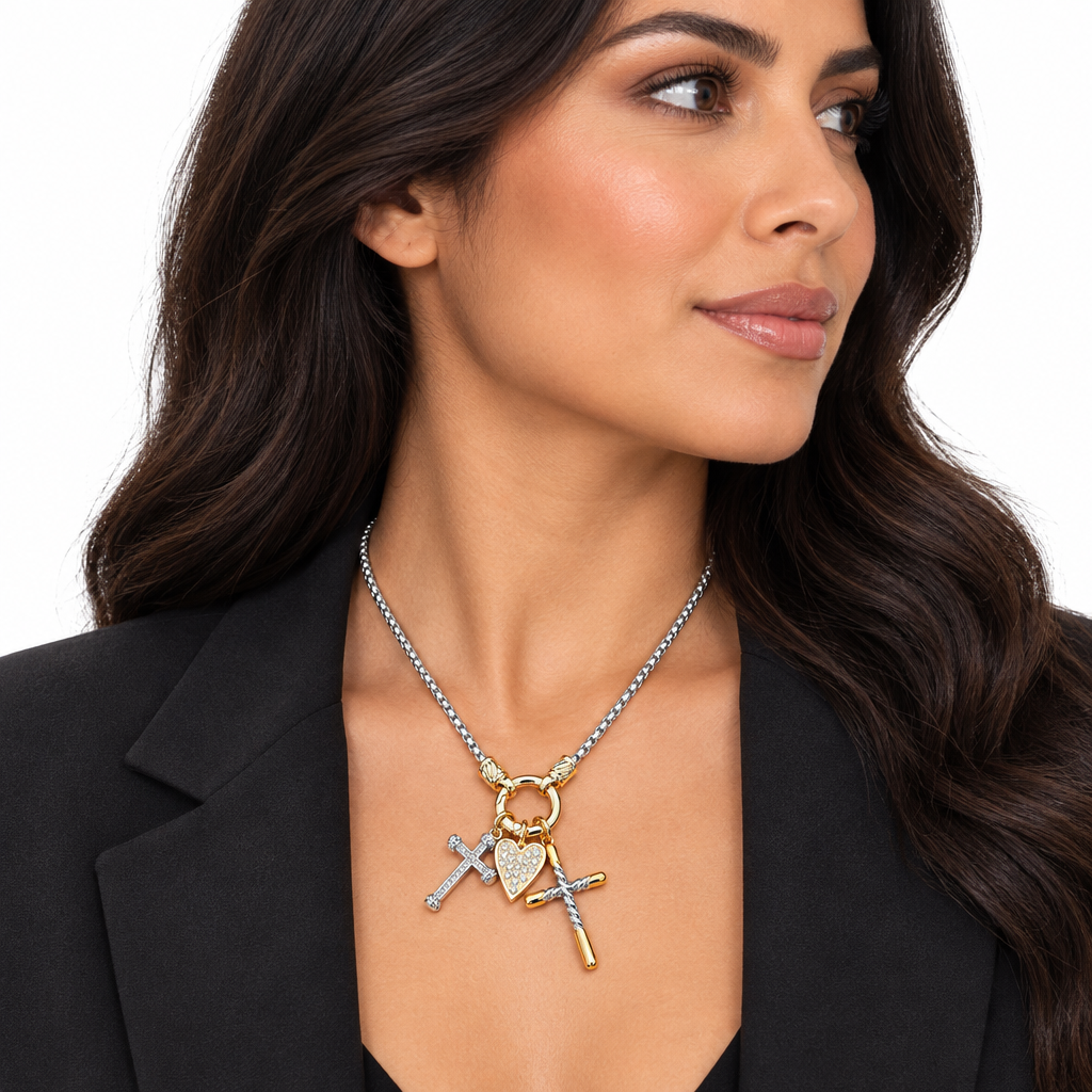 Woman wearing two-tone heart and cross charm necklace, side view