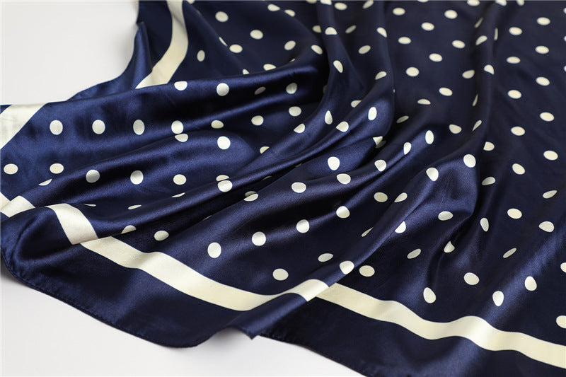 Navy blue polka dot silky square scarf laid flat showing full 35x35 inch dimensions