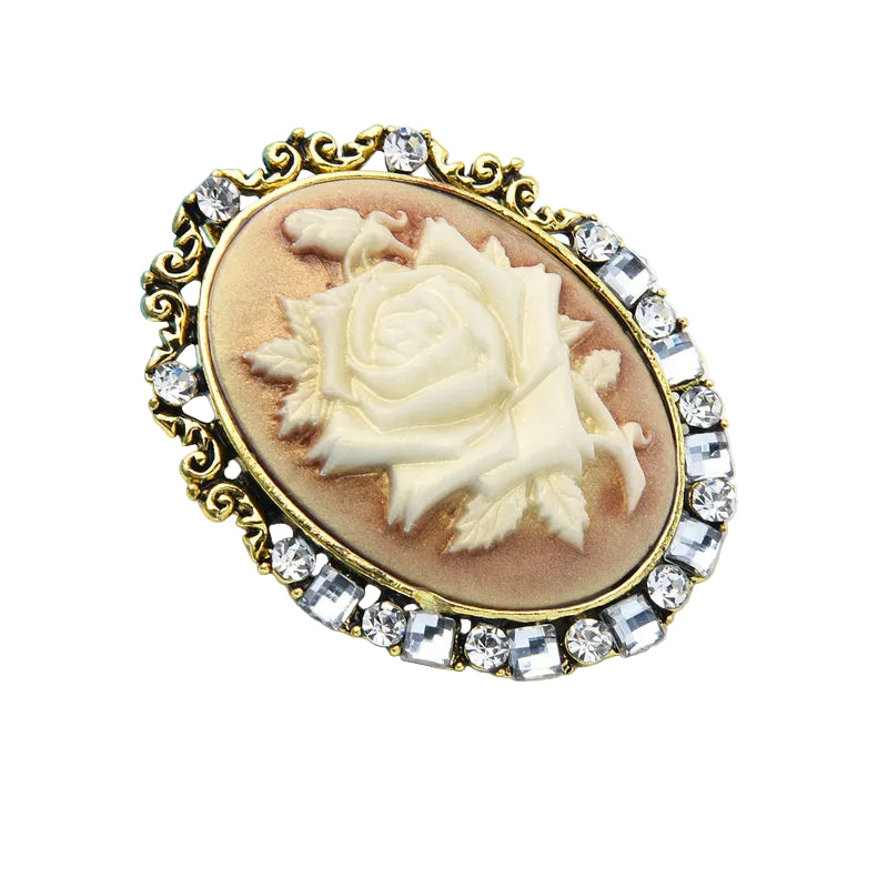 Vintage cameo rose brooch with crystal rhinestone frame in antique gold, angled lifestyle view