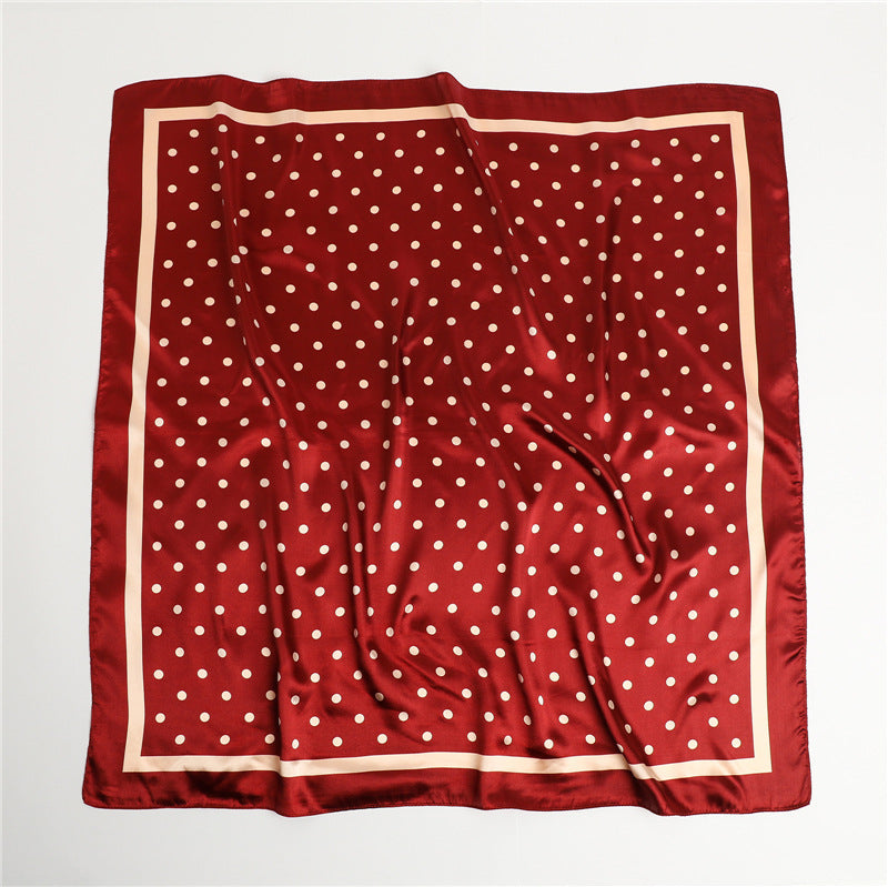Black and white polka dot satin square scarf flat lay showing white border frame