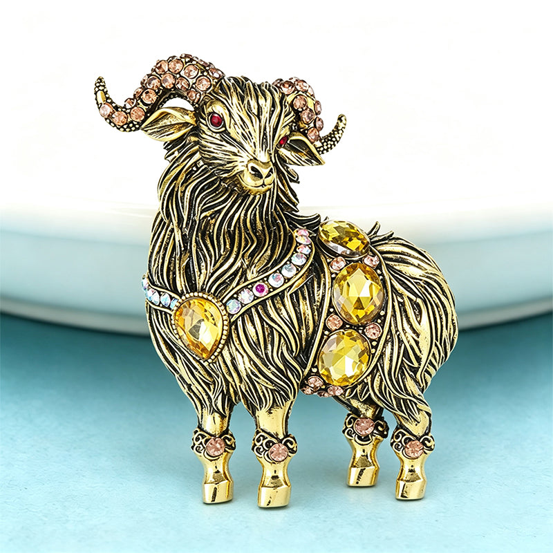 Antique gold crystal ram brooch close-up showing intricate textured fur detail and citrine stones