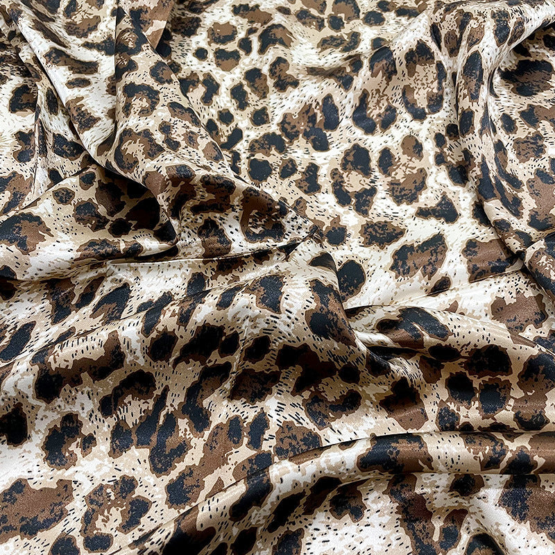Close-up of satin weave texture and black ivory border detail on leopard print scarf