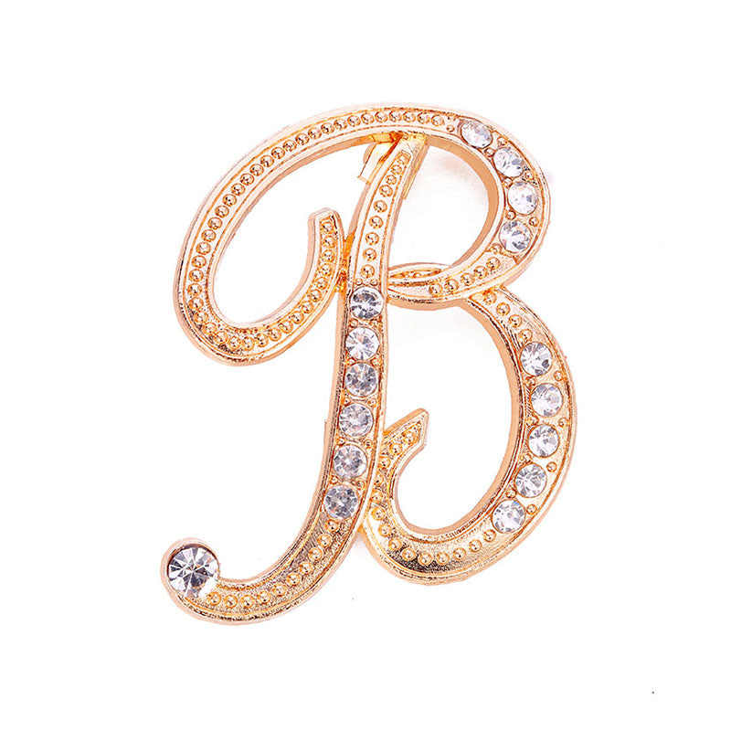 Gold crystal initial B letter brooch pin with rhinestone embellishments on white background