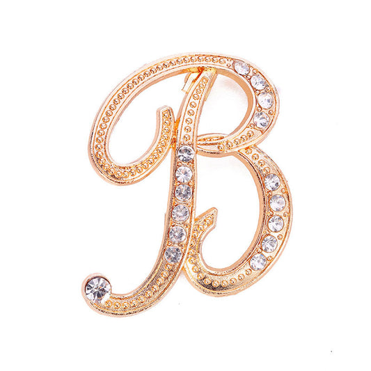 Gold crystal initial B letter brooch pin with rhinestone embellishments on white background