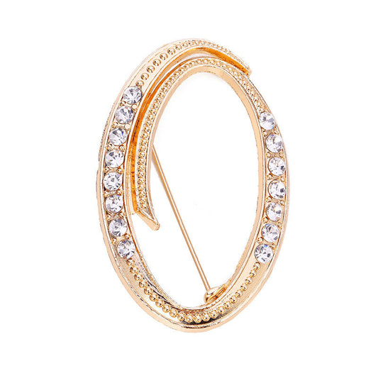 Gold crystal initial O letter brooch pin with rhinestone embellishments on white background