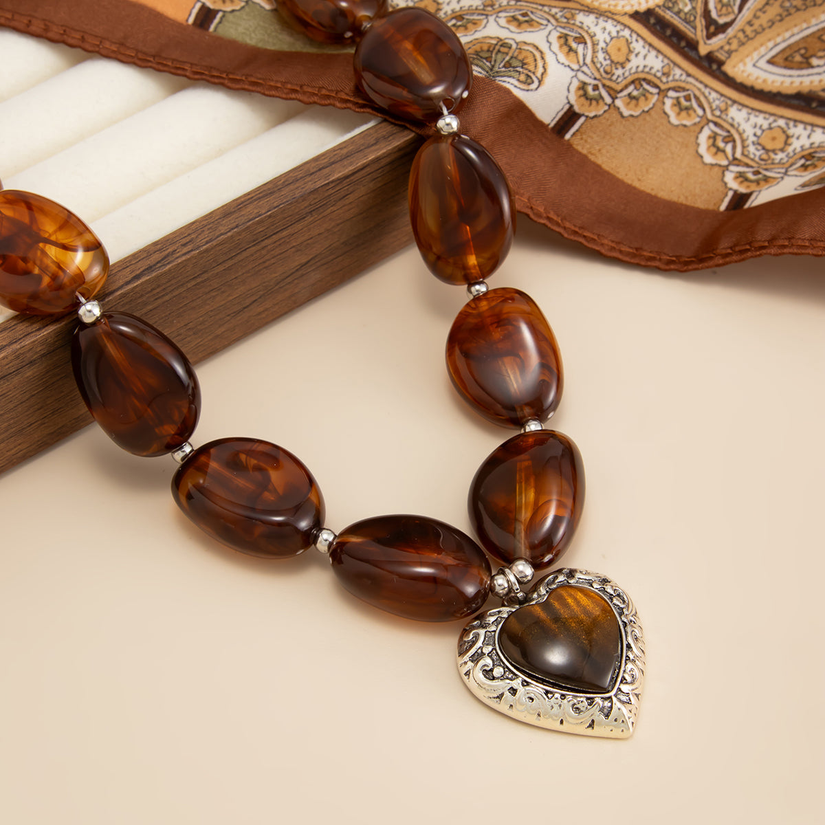 Tortoiseshell amber bead necklace - engraved silver heart pendant detail
