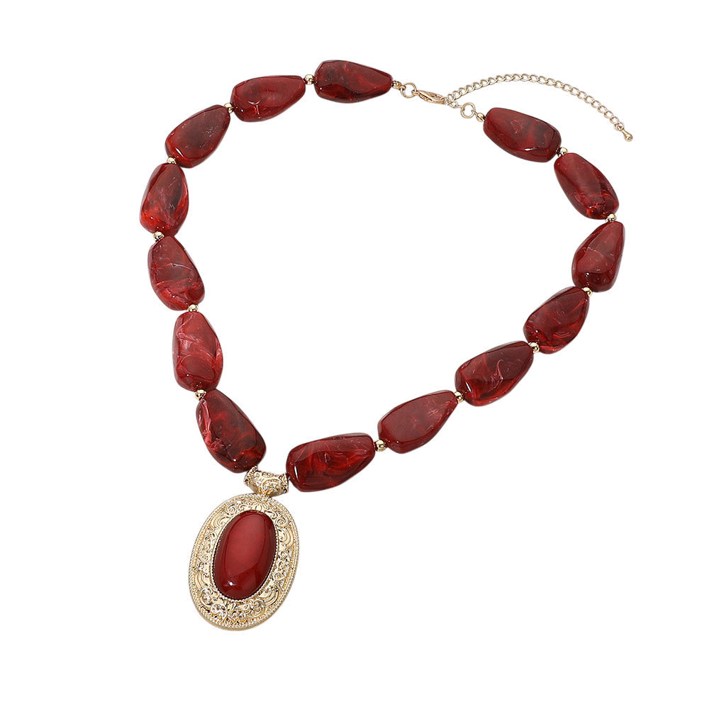 Crimson beaded statement necklace with gold filigree pendant - full view on white background