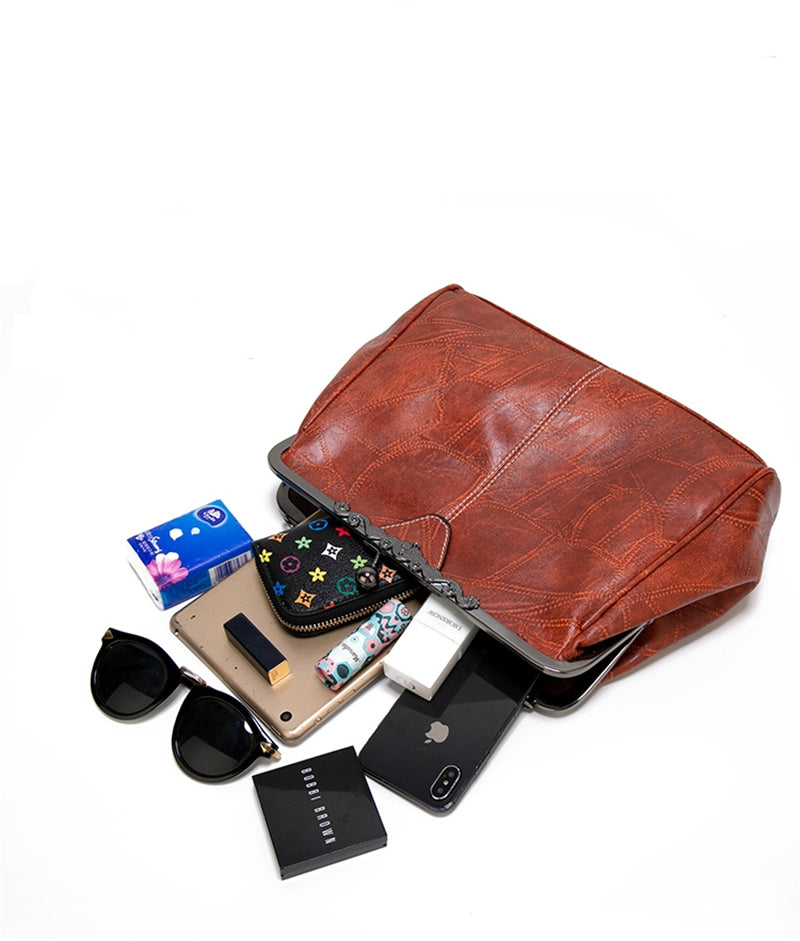 Interior capacity of vintage kiss-lock bag showing phone, sunglasses, wallet, makeup and more