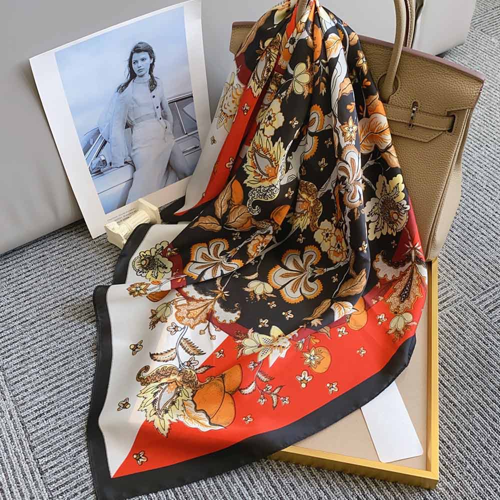 Women's square floral scarf tied as neck wrap on white background