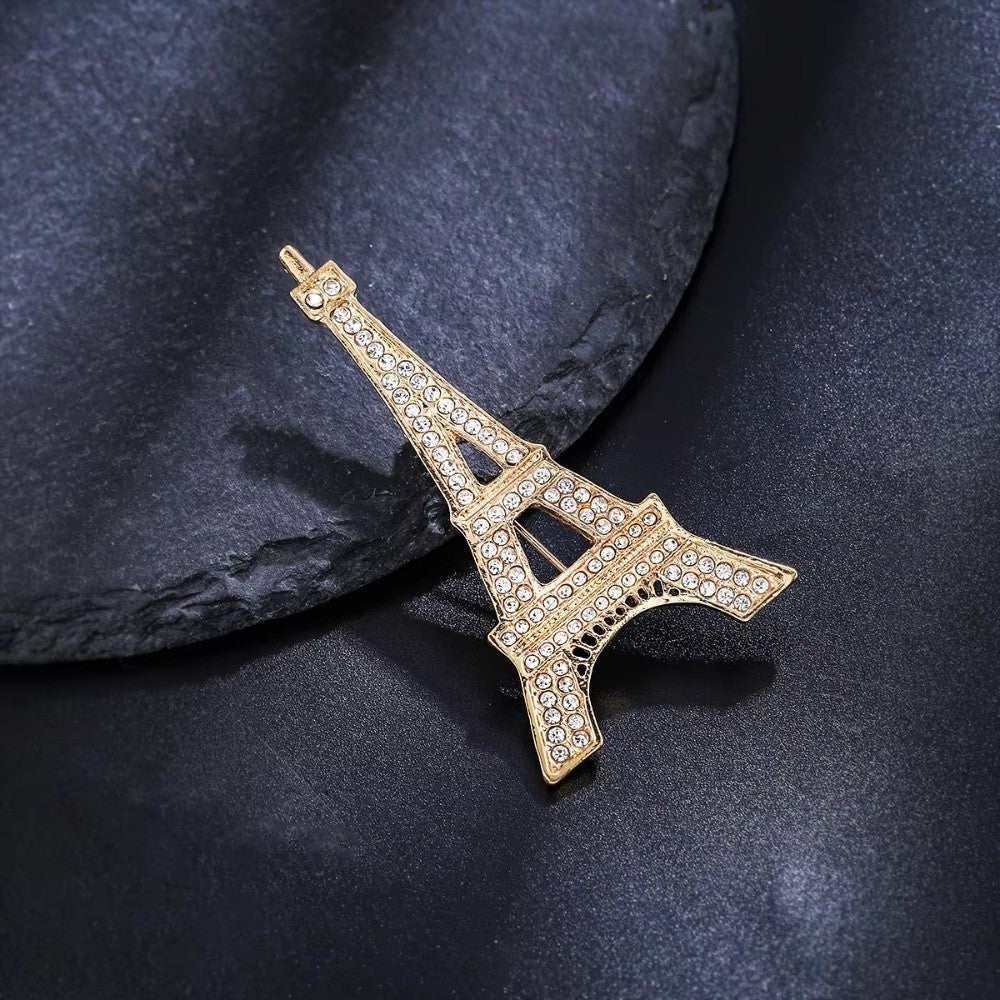 Crystal rhinestone Eiffel Tower brooch – front view on green background