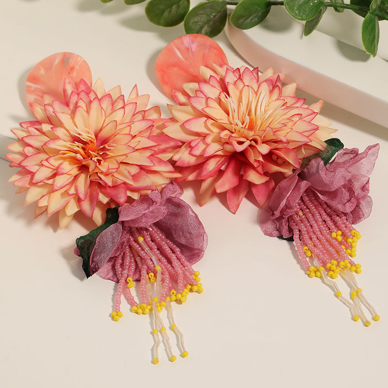 Dahlia flower beaded tassel drop earrings in coral pink - flatlay view