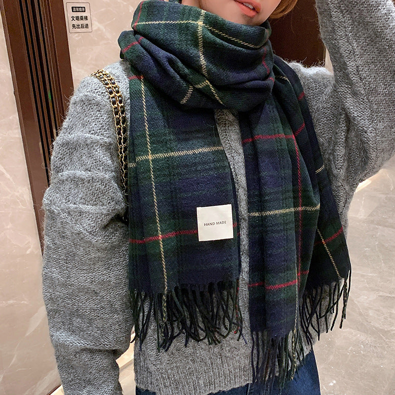 Navy green tartan plaid cashmere-feel scarf worn draped around neck over grey knit sweater