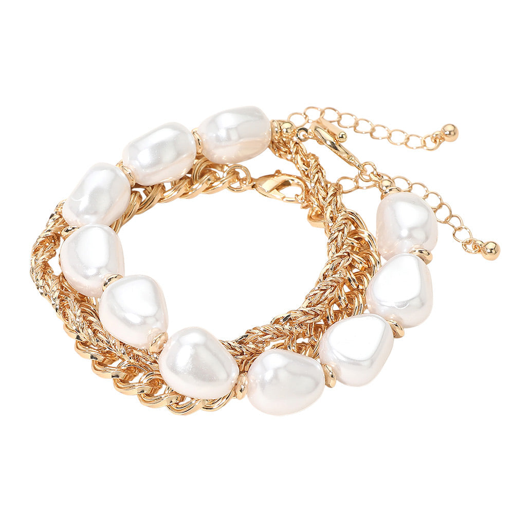 Baroque pearl multi-chain gold bracelet coiled on white background