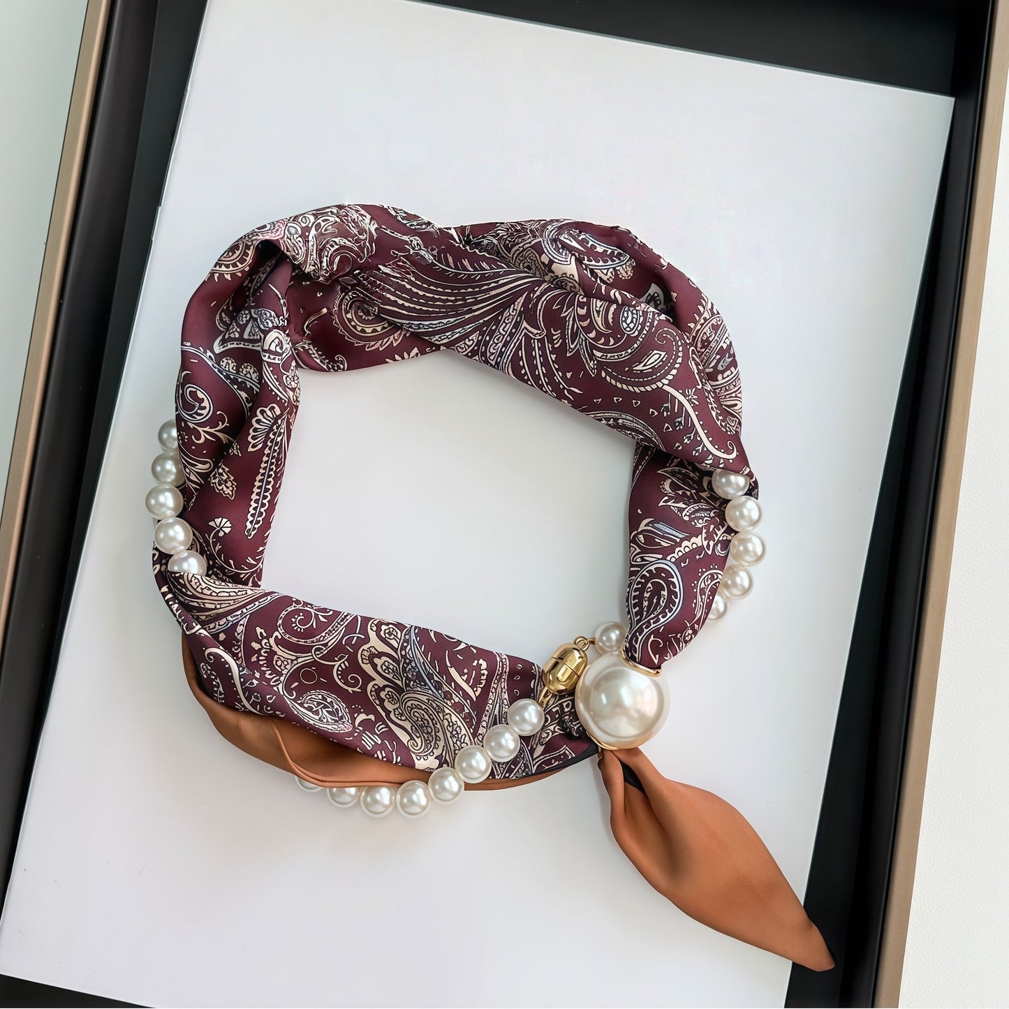 Burgundy paisley pearl-clasp silk-feel neckerchief coiled in gift box – flat lay