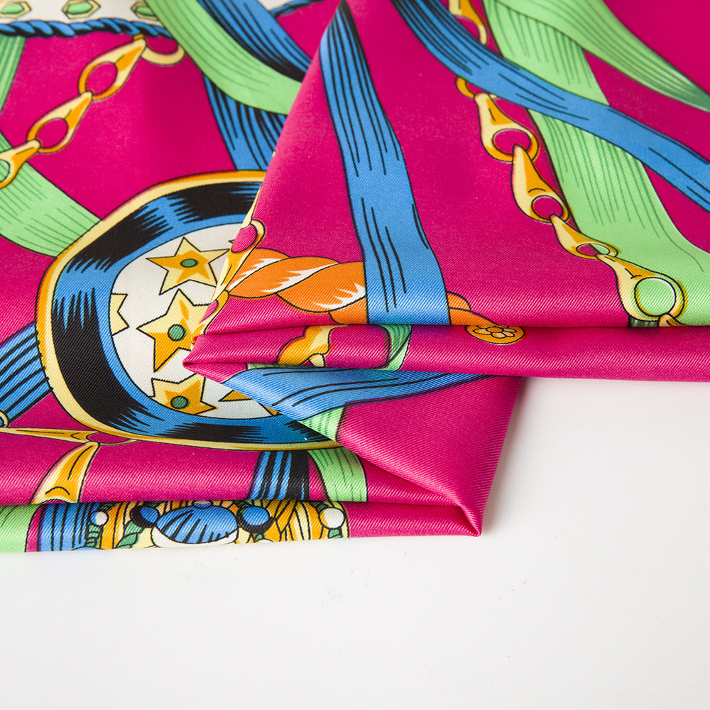 100% silk label on fuchsia scarf with colorful chain and tassel print