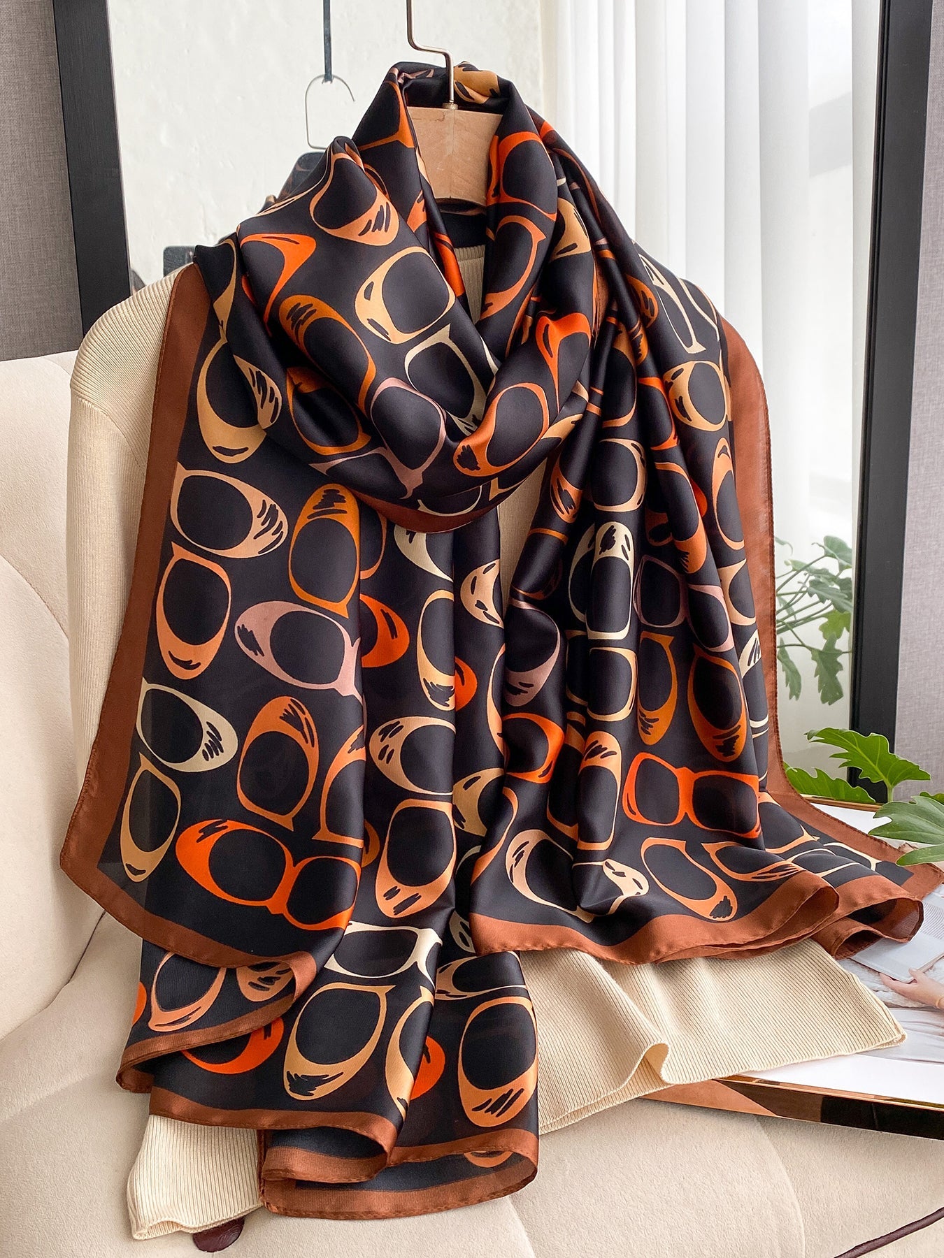 Retro sunglasses print silk-feel scarf styled on a hanger showing drape and length