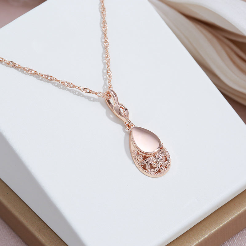 Rose gold filigree teardrop pendant necklace side angle