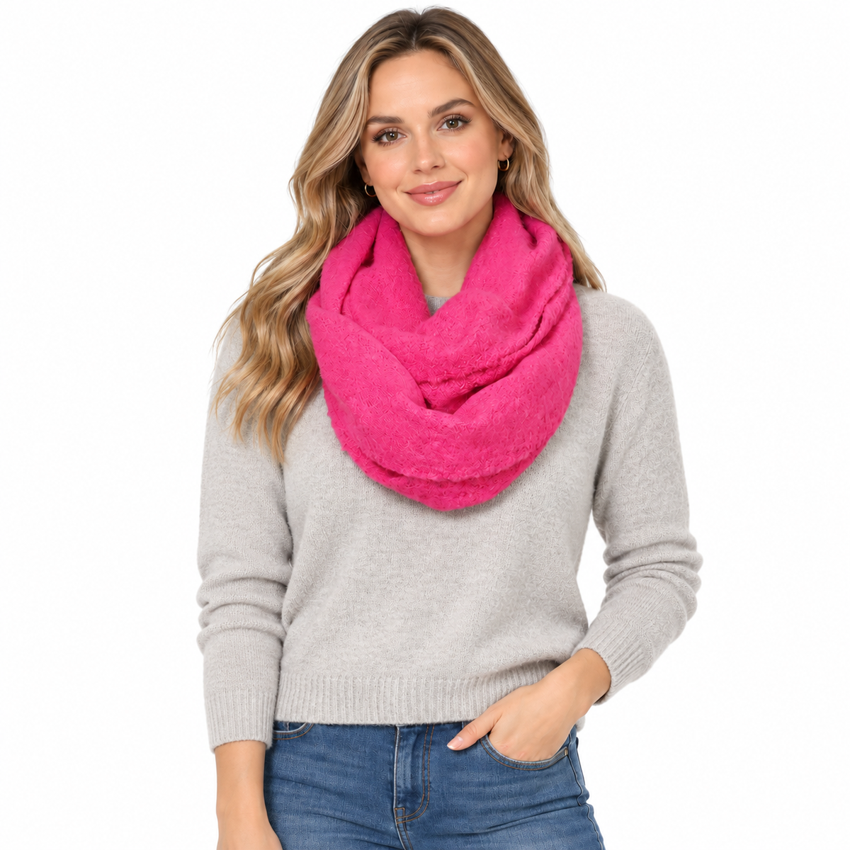 Woman wearing hot pink infinity scarf styled over grey sweater, lifestyle shot
