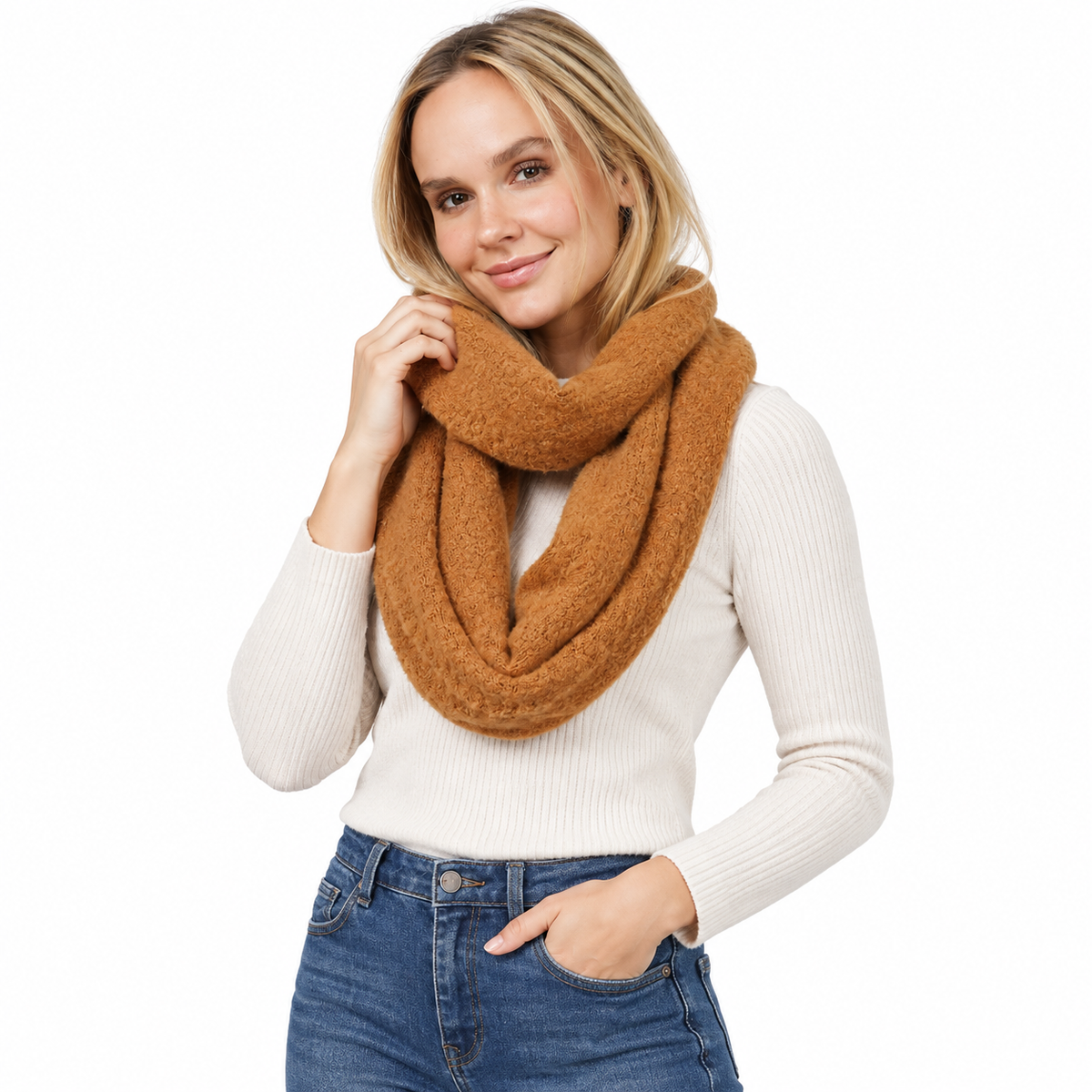 Woman wearing camel chunky knit infinity scarf with white ribbed sweater and jeans