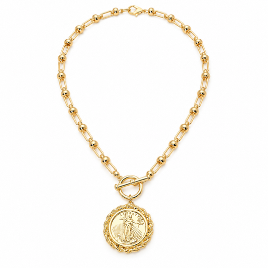 Gold Liberty coin pendant necklace with ornate rope-textured border on warm background