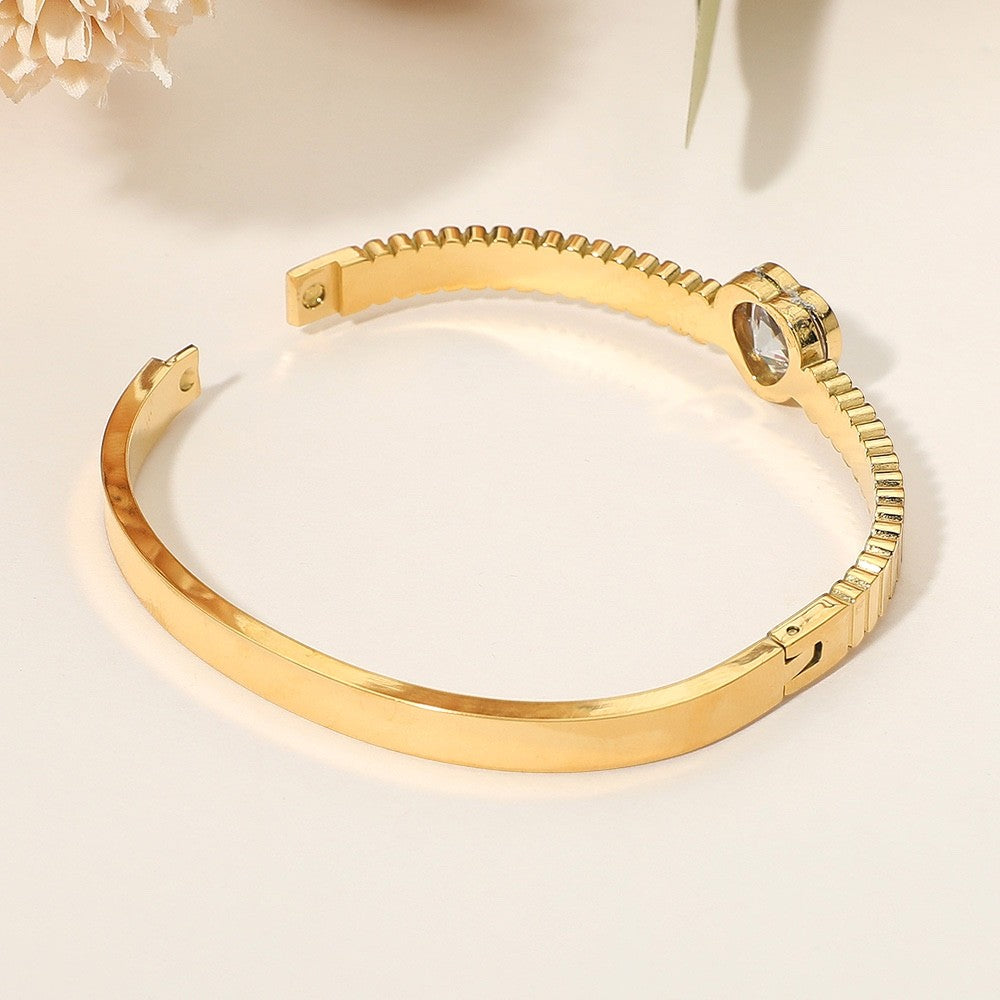 Gold Grooved Stainless Steel Bangle Bracelet with Pink Heart Crystal Center
