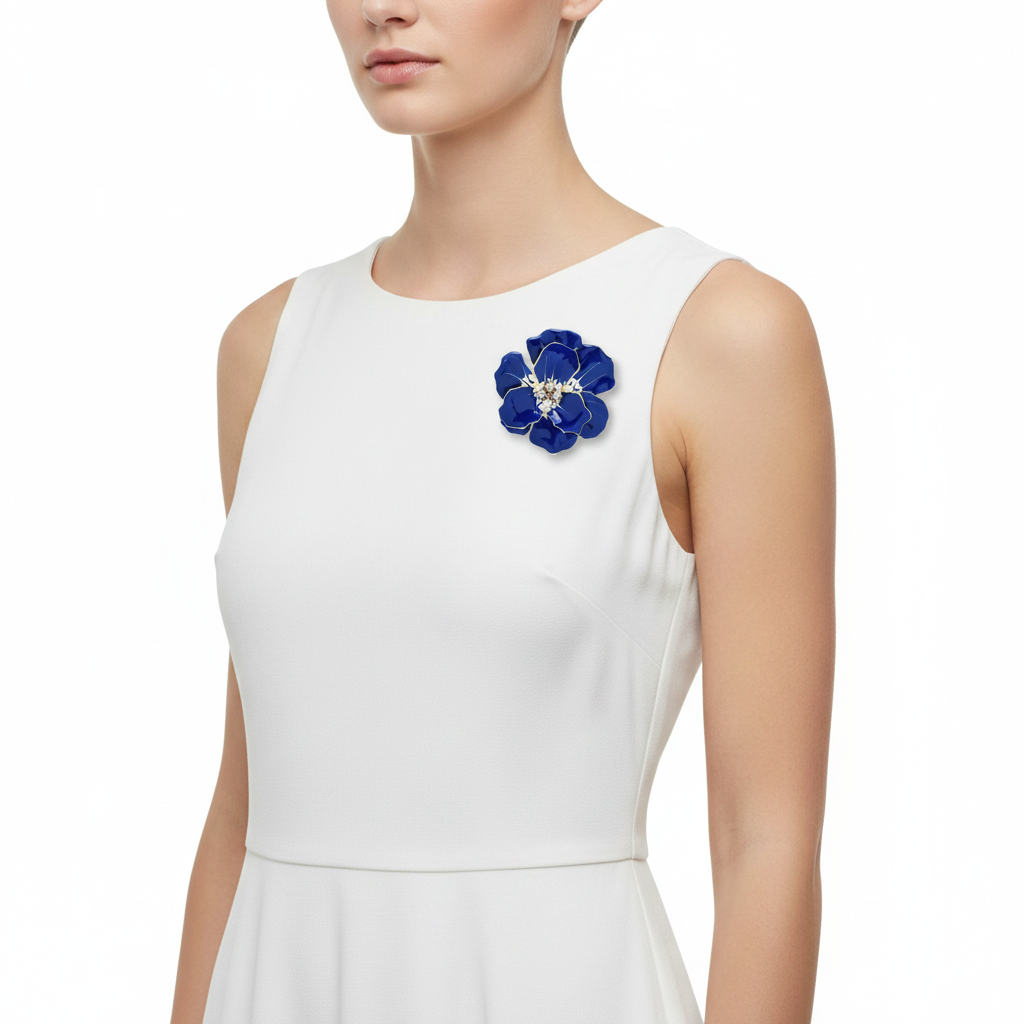 Blue enamel brooch on white summer dress
