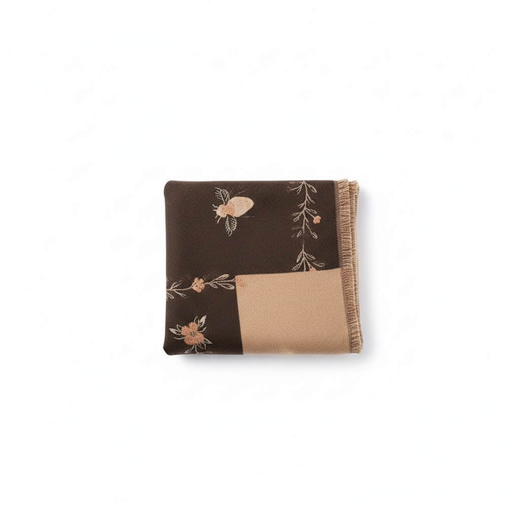 Embroidered bee and floral shawl wrap in dark brown with beige accents, folded on white background