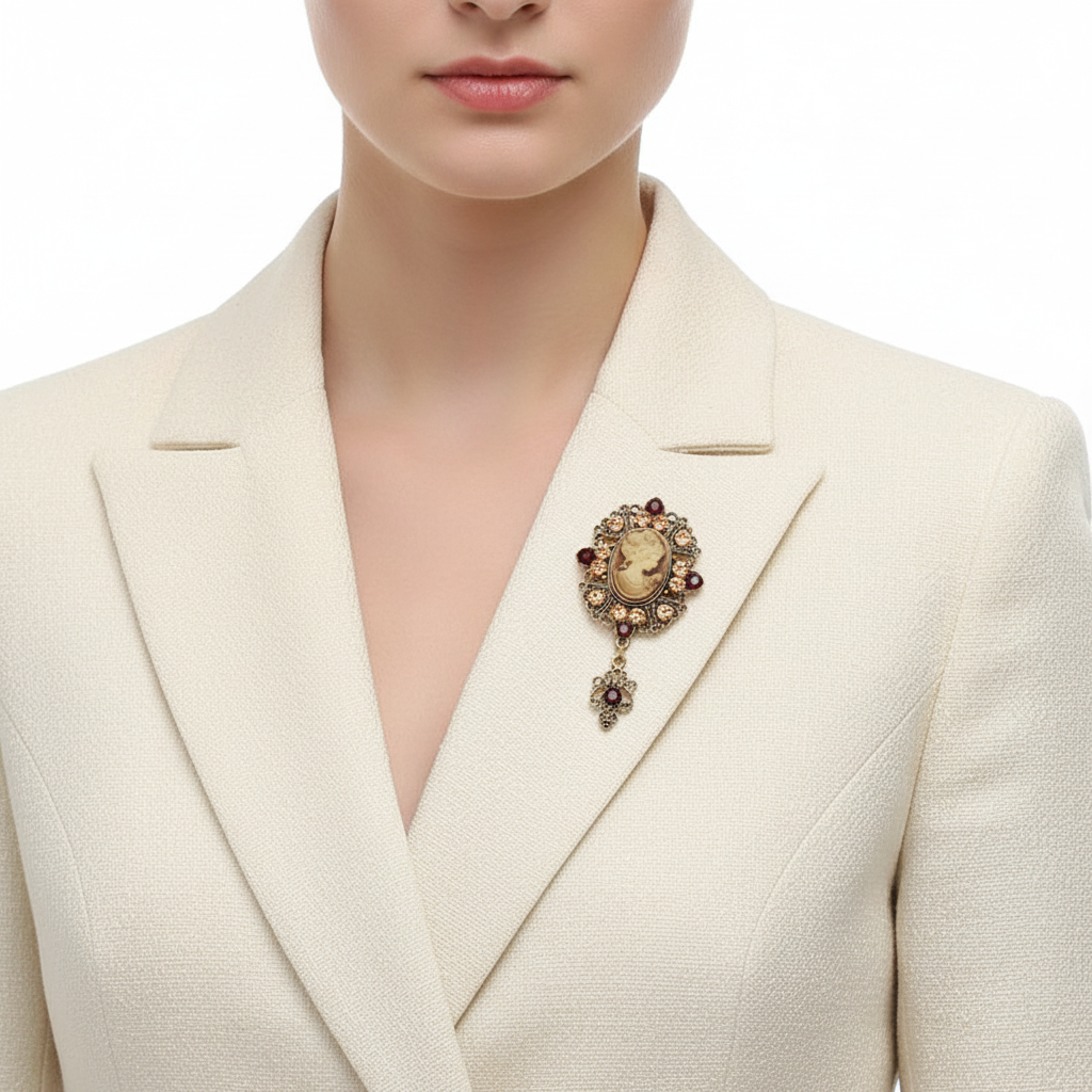 Woman wearing vintage cameo brooch pinned to cream blazer lapel, front view
