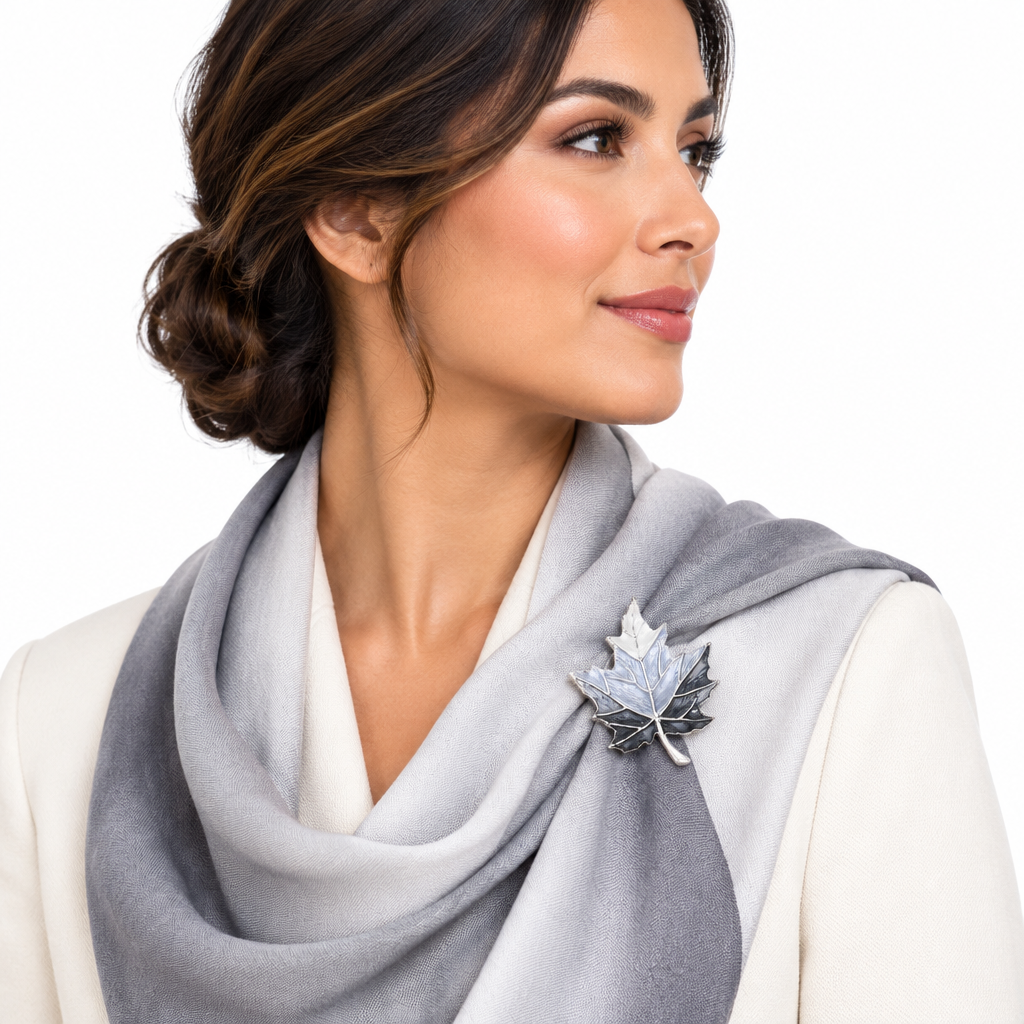Hispanic woman wearing a silver-tone enamel maple leaf magnetic brooch on a draped scarf