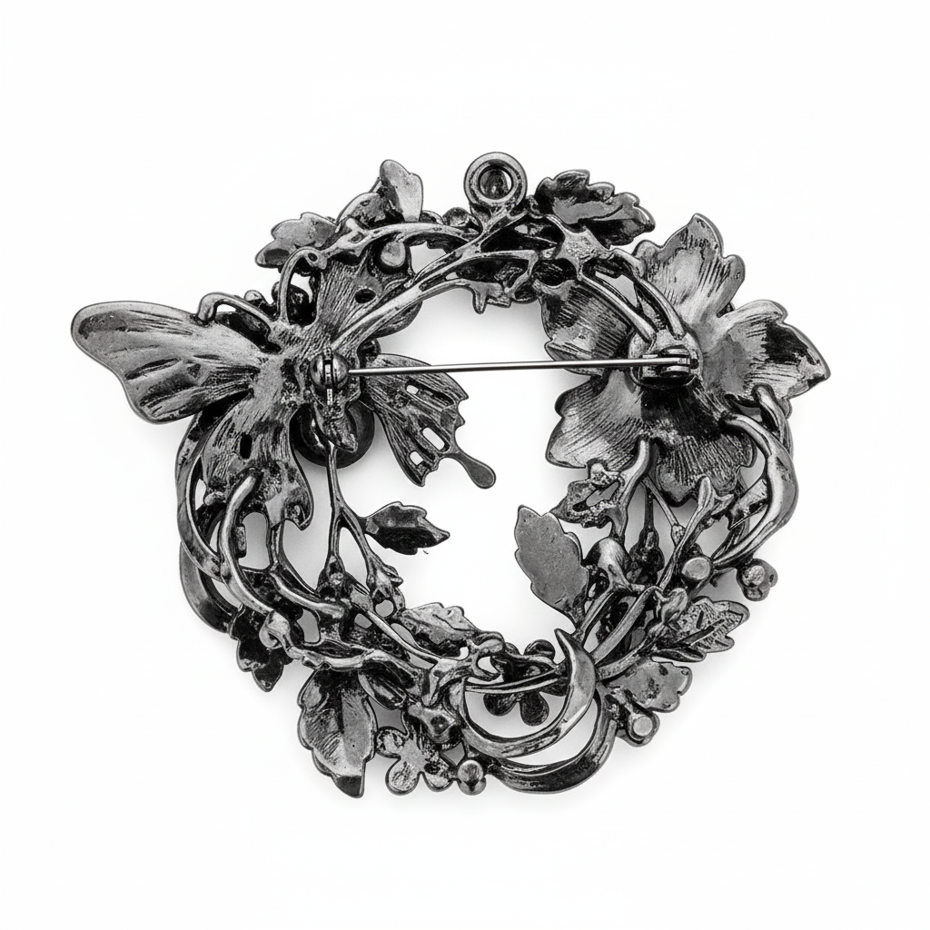 Back of butterfly floral rhinestone brooch pendant showing pin closure and pendant opening